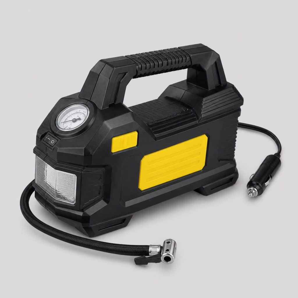 Compresseur gonfleur de pneu moto portable posé sur fond clair